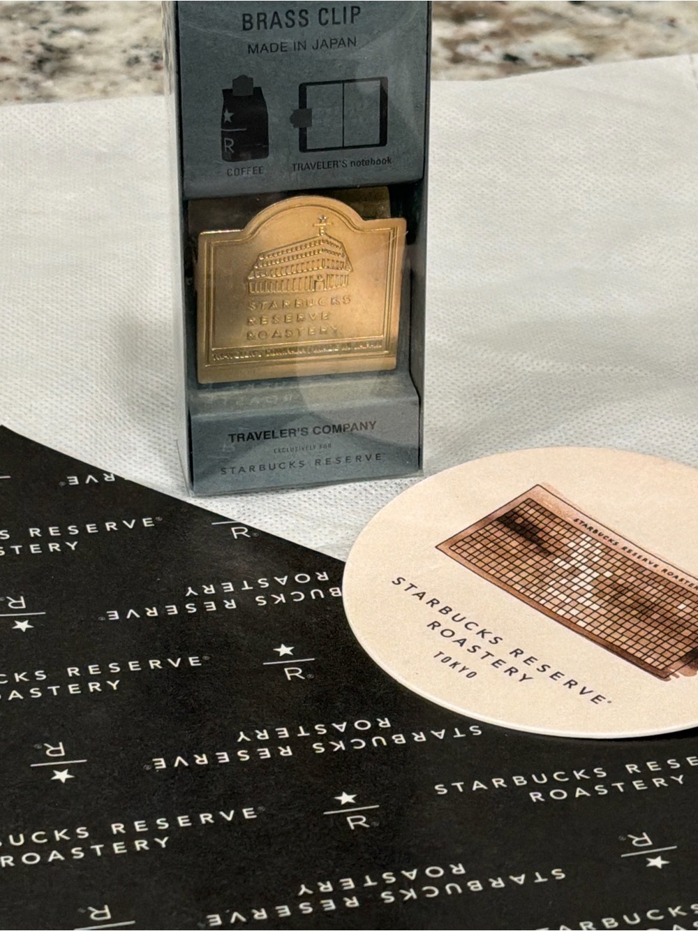 Starbucks gold brass clip and black/cream branded coasters
